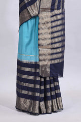Blue zari design mushru silk saree with contrast striped zari border and blouse
