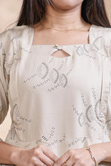 Off White floral printed A-line maternity wear with 3/4 sleeves and keyhole neck
