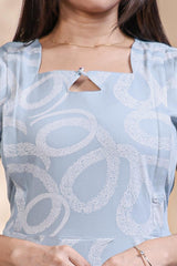 Baby blue abstract printed A-line maternity wear with 3/4 sleeves and keyhole neck