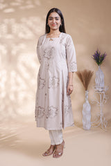 Beige floral printed A-line maternity wear with 3/4 sleeves and keyhole neck