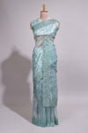 Pastel blue organza saree featuring delicate floral embroidery, intricate lace detailing on the border and pallu with a scalloped finishing along with matching blouse