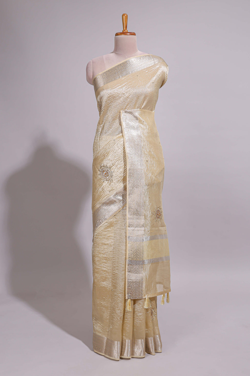 Cream organza saree featuring delicate floral embroidery intricate with silver  border along with blouse