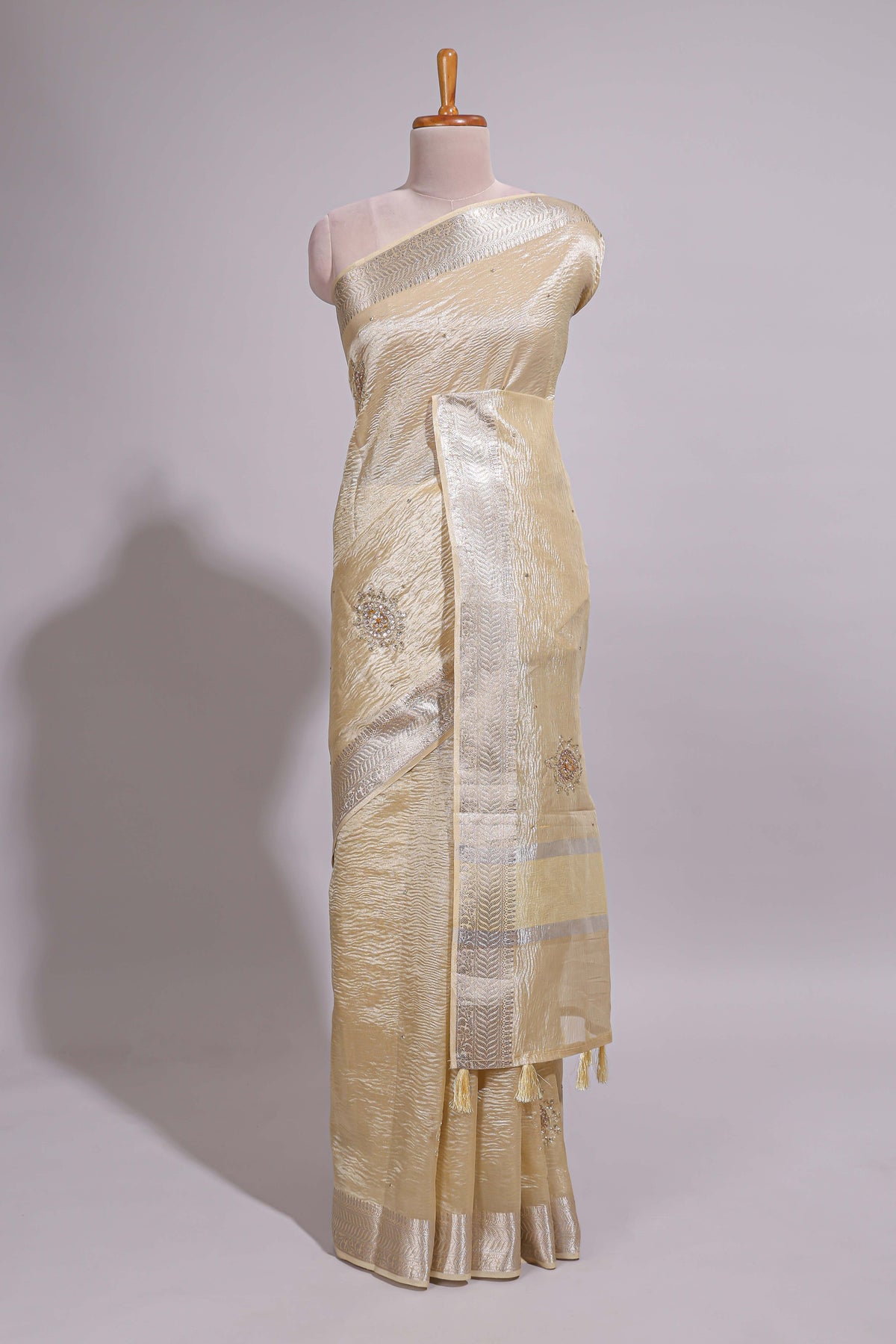 Cream organza saree featuring delicate floral embroidery intricate with silver  border along with blouse