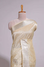 Cream organza saree featuring delicate floral embroidery intricate with silver  border along with blouse