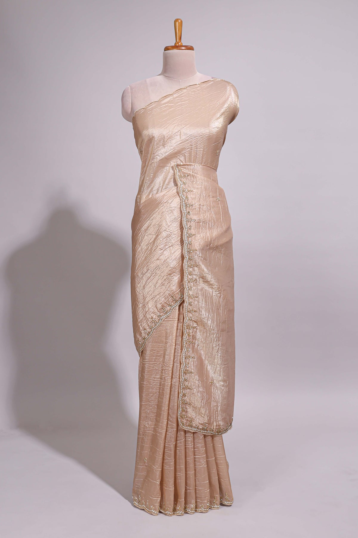 Ivory beige organza saree with plain body border and pallu with a scalloped finishing along with matching blouse