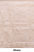 Ivory beige organza saree with plain body border and pallu with a scalloped finishing along with matching blouse