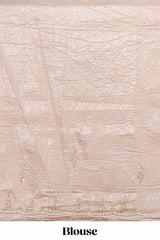 Ivory beige organza saree with plain body border and pallu with a scalloped finishing along with matching blouse