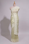 Pastel ivory organza saree with delicate floral embroidery intricate lace border and scalloped pallu detailing