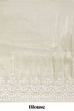 Pastel ivory organza saree with delicate floral embroidery intricate lace border and scalloped pallu detailing