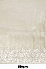 Pastel ivory organza saree with delicate floral embroidery intricate lace border and scalloped pallu detailing