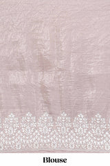 Soft blush pink organza saree with delicate floral embroidery intricate lace border and scalloped pallu detailing