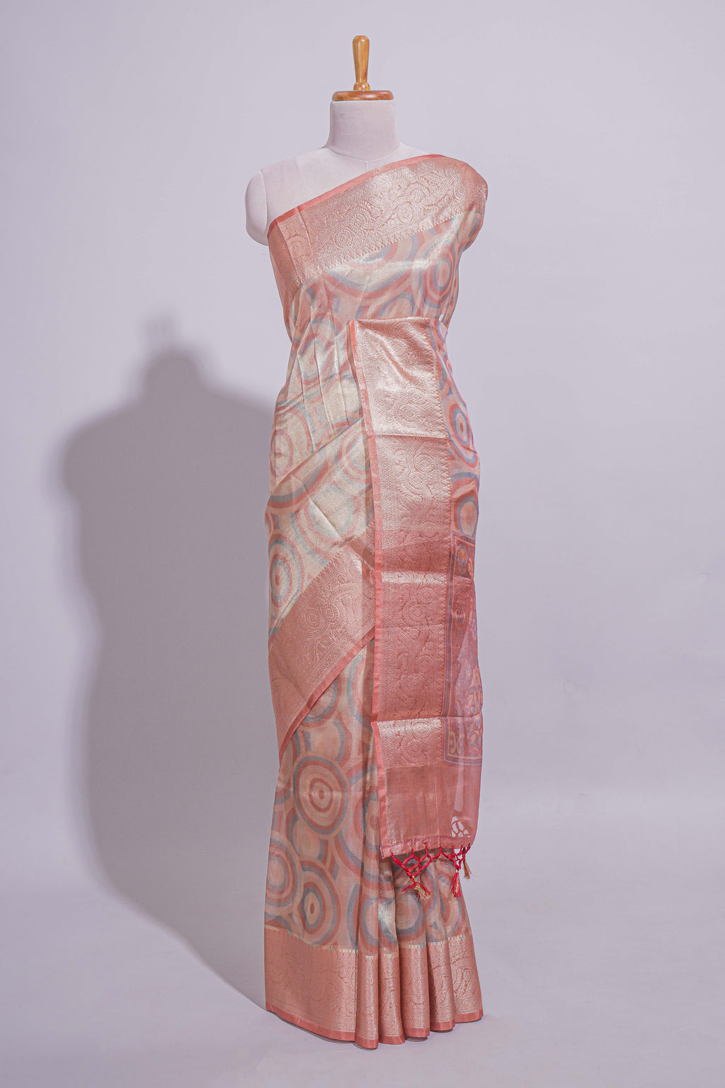 Peach Shade Geometric Design organza saree with Zari border and matching floral motifs blouse