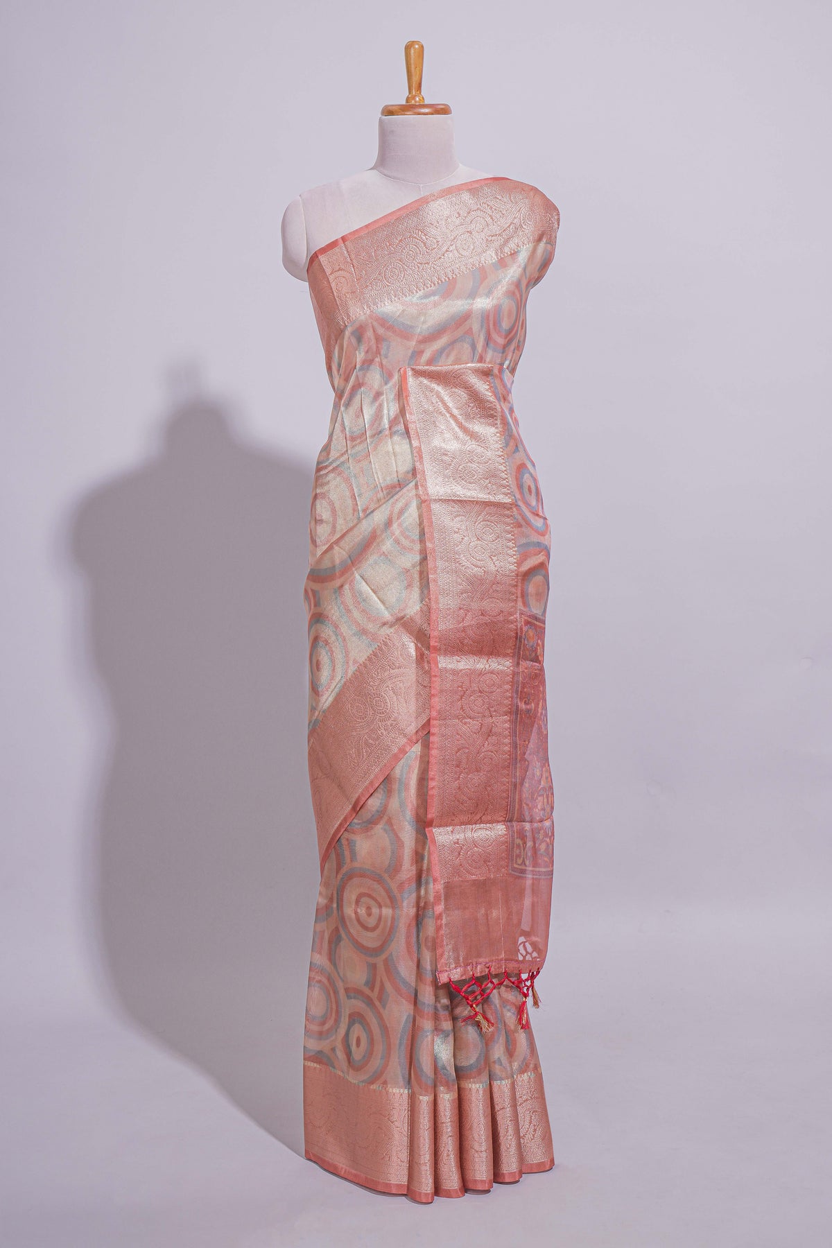 Peach Shade Geometric Design organza saree with Zari border and matching floral motifs blouse