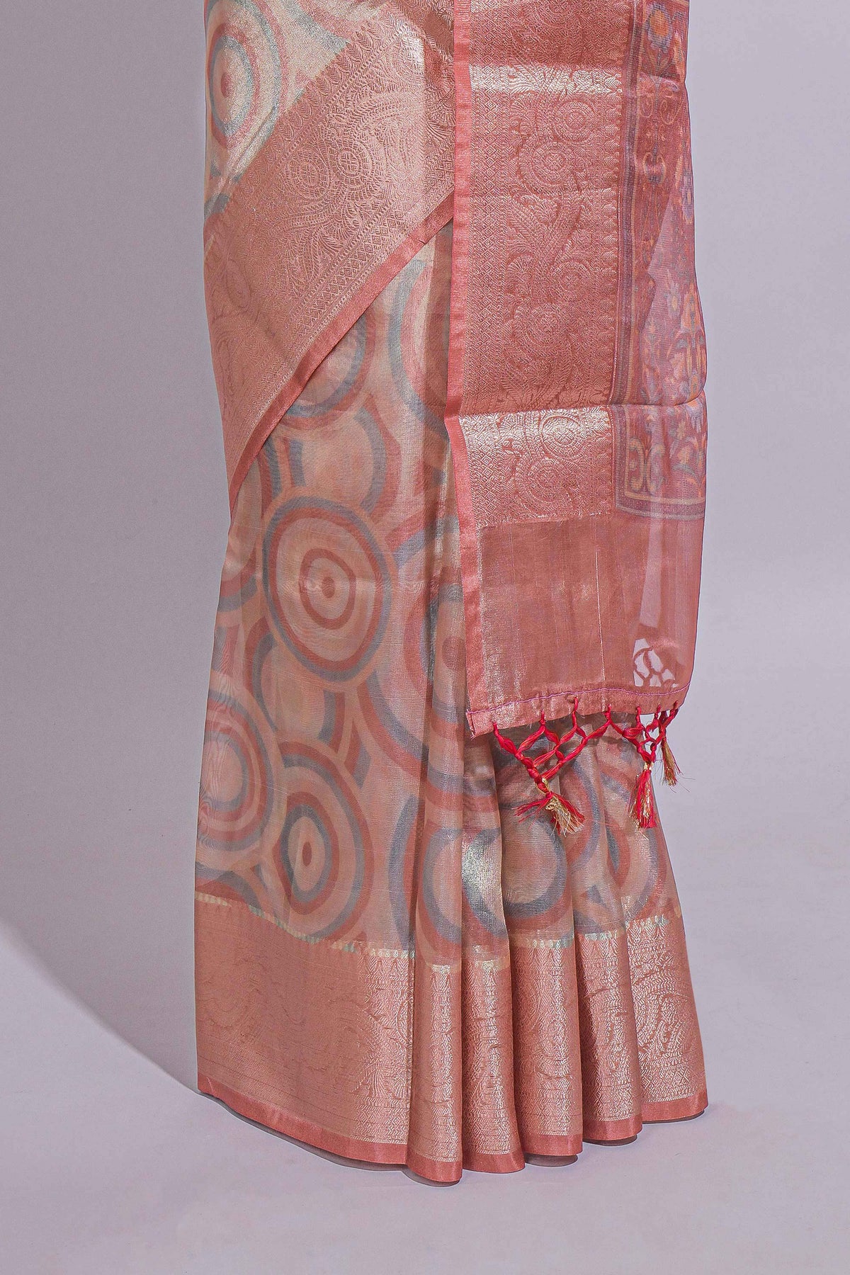 Peach Shade Geometric Design organza saree with Zari border and matching floral motifs blouse