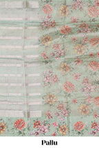 Green striped design organza saree with floral design border and matching floral motifs blouse