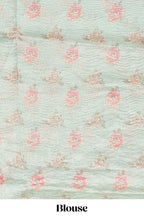 Green striped design organza saree with floral design border and matching floral motifs blouse