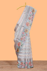 Grey shade striped design organza saree with floral design border and matching floral motifs blouse