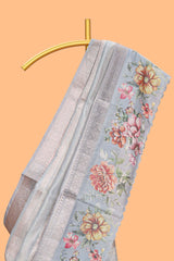 Grey shade striped design organza saree with floral design border and matching floral motifs blouse