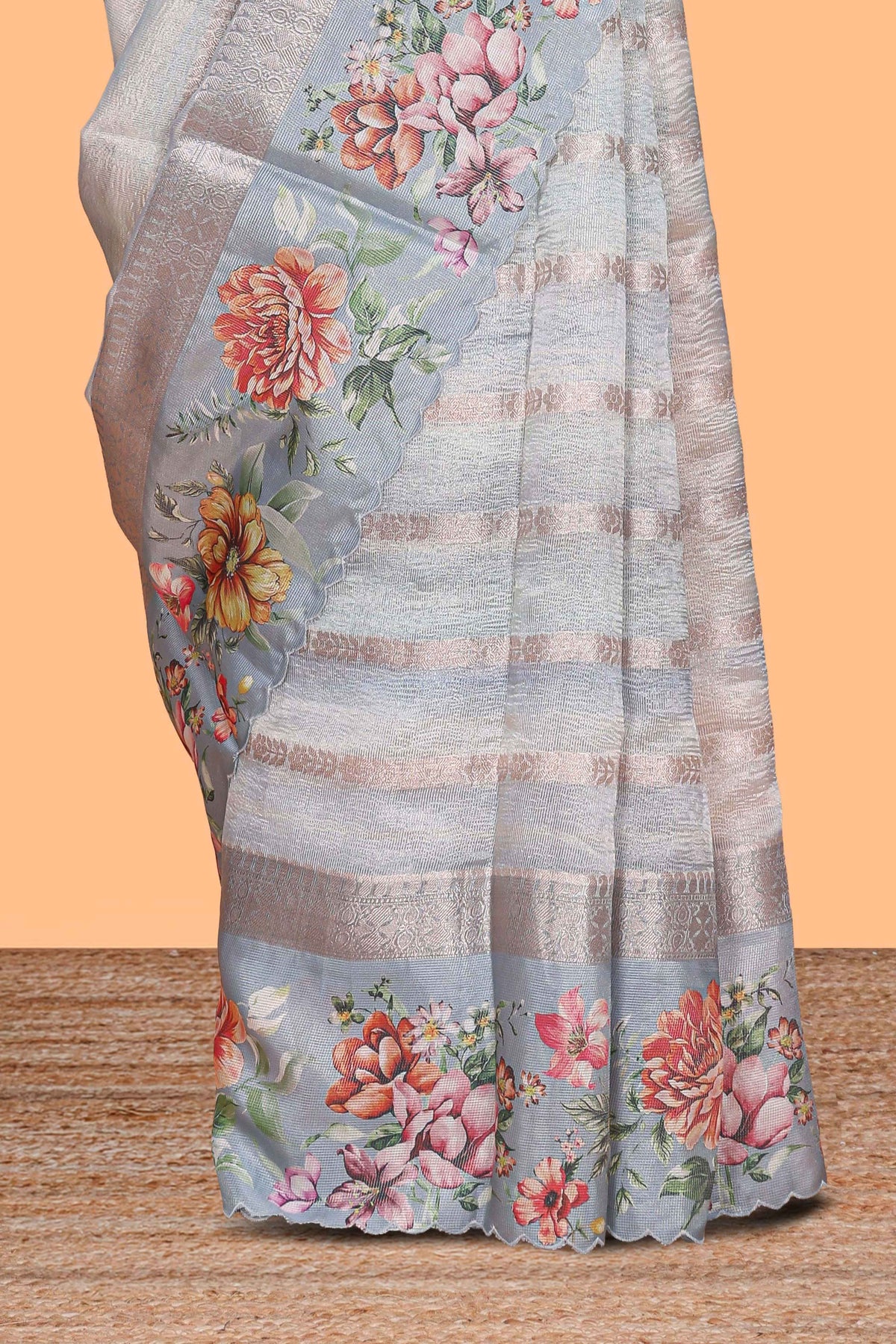 Grey shade striped design organza saree with floral design border and matching floral motifs blouse