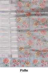 Grey shade striped design organza saree with floral design border and matching floral motifs blouse