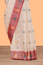 Cream floral design banarasi silk saree with contrast border and floral printed blouse