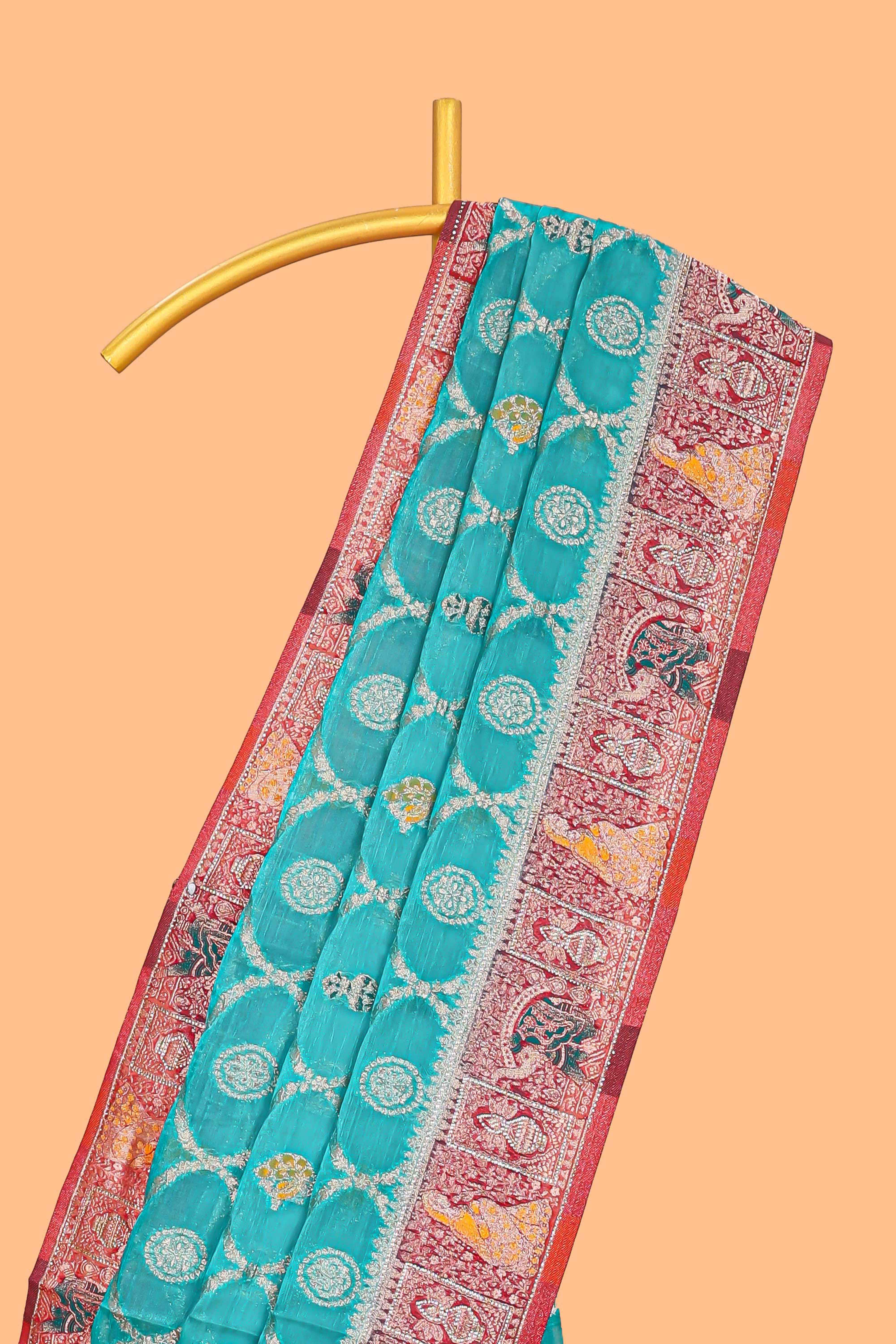 Turquoise blue floral design banarasi silk saree with contrast border and floral printed blouse