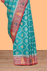 Turquoise blue floral design banarasi silk saree with contrast border and floral printed blouse