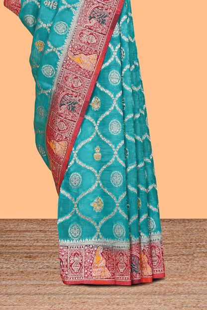 Turquoise blue floral design banarasi silk saree with contrast border and floral printed blouse