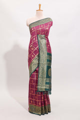 Magenta all-over checked grid pattern and butta banarasi silk saree with green contrast floral zari border and buttas blouse
