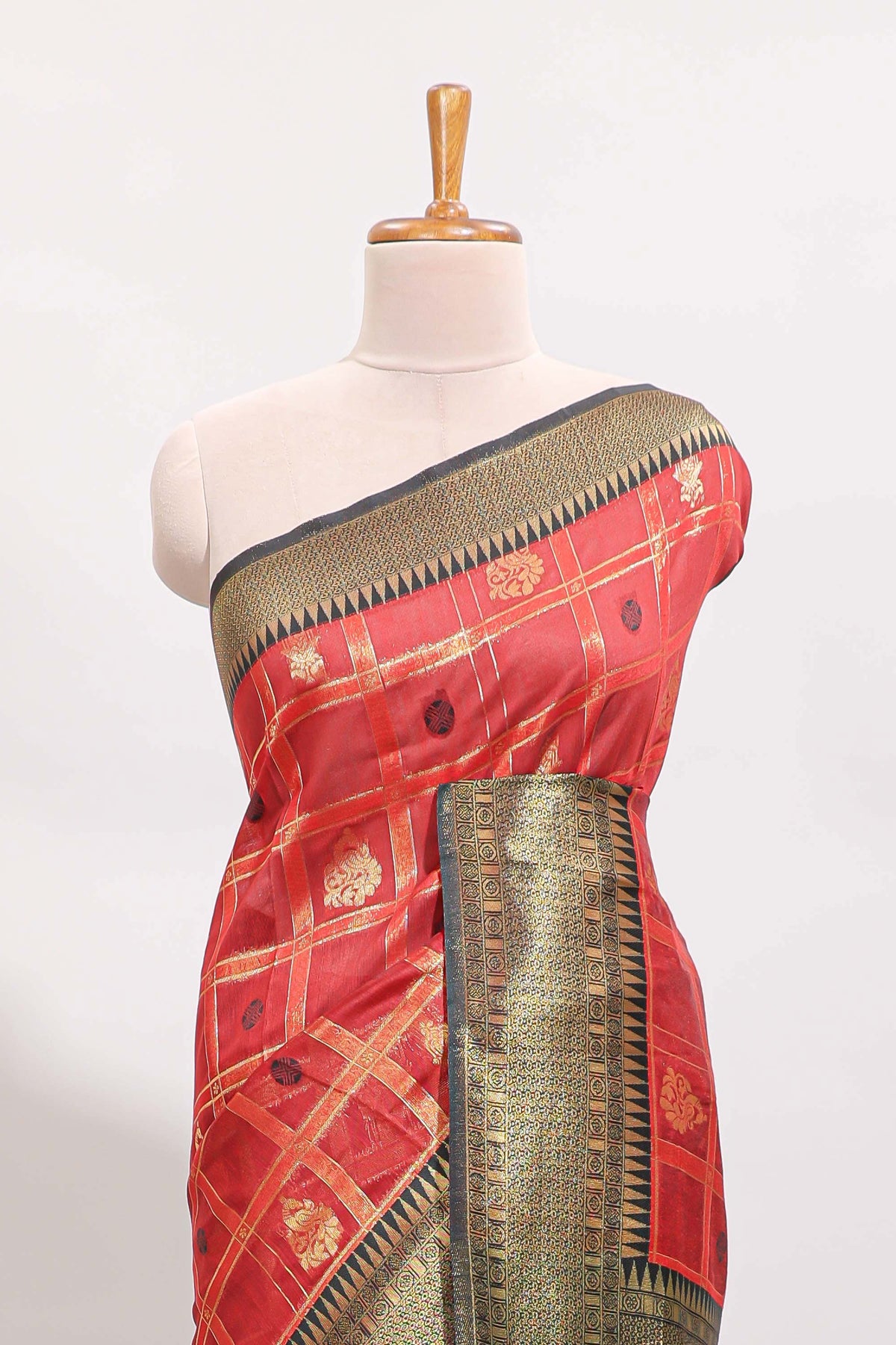 Red shade checked and butta banarasi silk saree with black contrast geometric zari border and buttas blouse