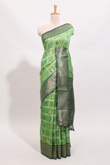 Green shade checked and butta banarasi silk saree with contrast geometric zari border and buttas blouse