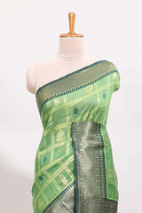 Green shade checked and butta banarasi silk saree with contrast geometric zari border and buttas blouse