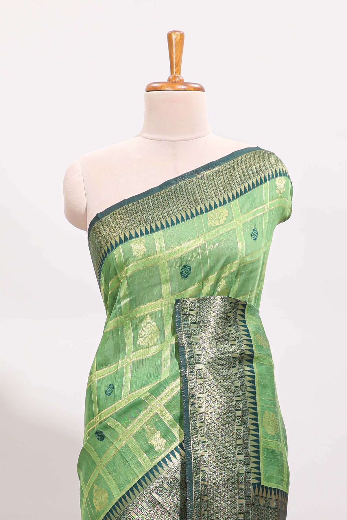 Green shade checked and butta banarasi silk saree with contrast geometric zari border and buttas blouse