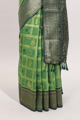 Green shade checked and butta banarasi silk saree with contrast geometric zari border and buttas blouse