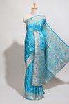 Blue shade floral designed banarasi silk saree with self zari border and blouse