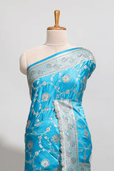 Blue shade floral designed banarasi silk saree with self zari border and blouse