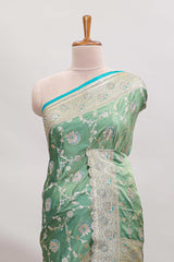 Sea green floral designed banarasi silk saree with self zari border and blouse