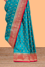Teal blue banarasi silk saree with contrast zari border and blouse