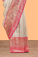 Cream unique designed banarasi silk saree with contrast floral zari border and blouse