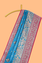 Blue floral designed banarasi silk saree with contrast floral border and matching blouse