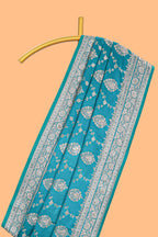 Blue floral designed banarasi silk saree with self floral border and matching blouse