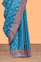 Peacock blue floral designed banarasi silk saree with self floral border and matching blouse