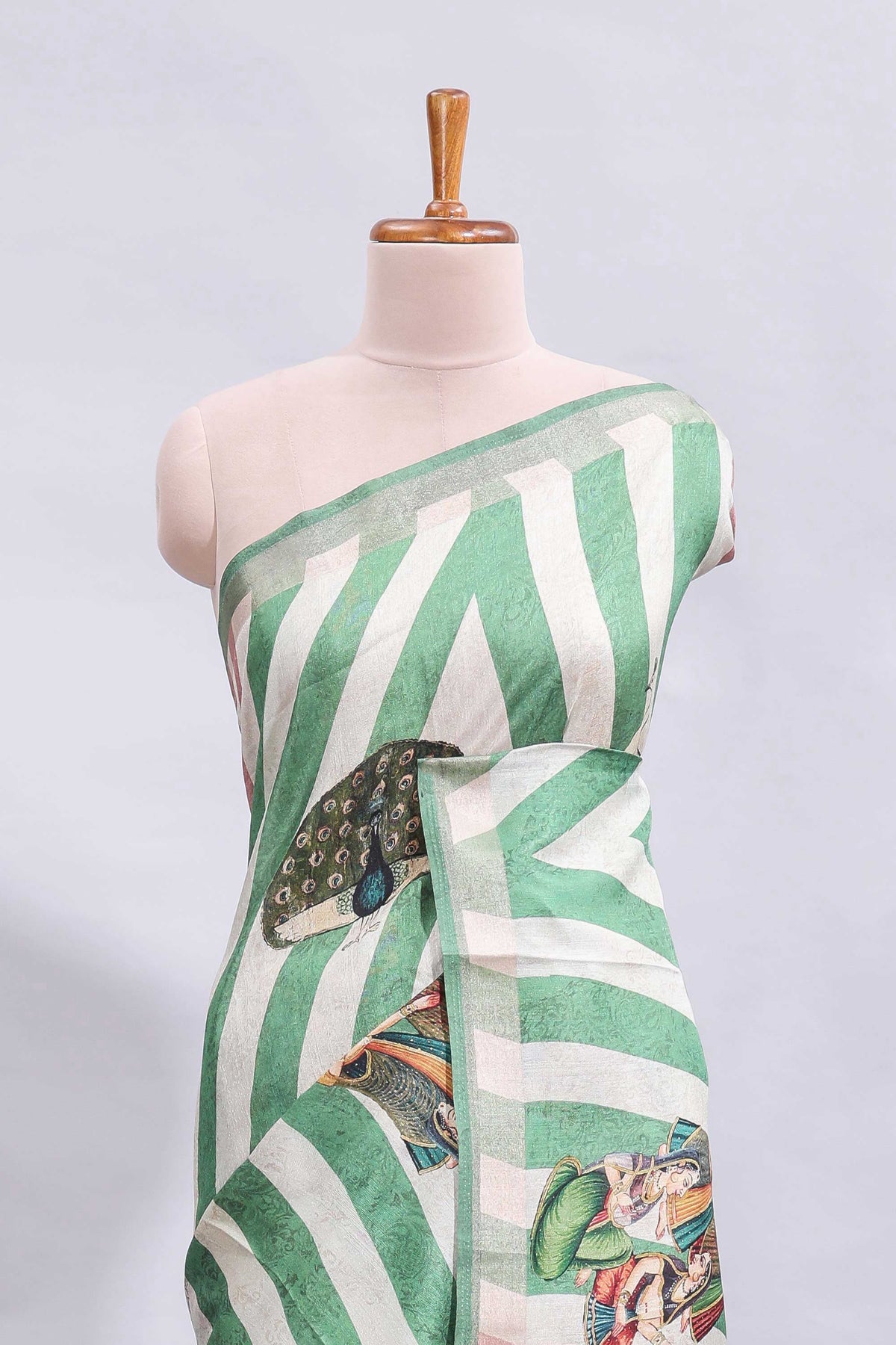 Off white & green striped peacock motifs design and self border and printed blouse