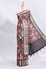 Maroon printed saree with traditional art motifs with contrast zari border and motifs blouse