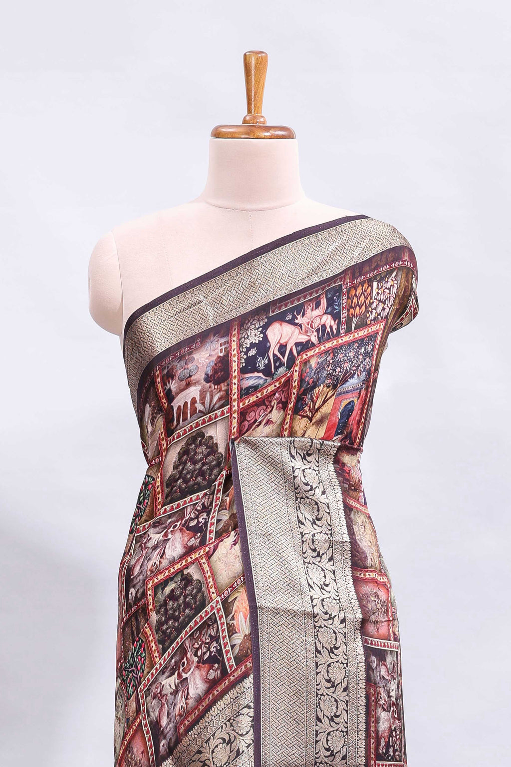 Maroon printed saree with traditional art motifs with contrast zari border and motifs blouse