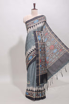 Grey ikkat style floral motifs tussar saree with contrast border and crane bird motif blouse
