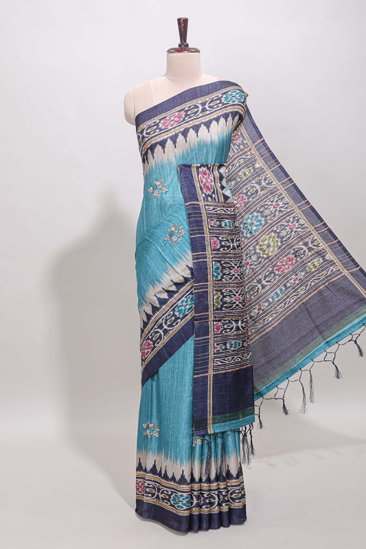 Blue ikkat style floral motifs tussar saree with contrast border and crane bird motif blouse