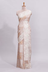 Beige striped design raw silk saree with self border and matching blouse