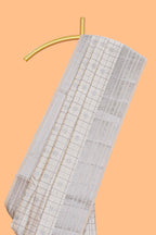 Off white checked zari design raw silk saree with self zari border and matching striped blouse