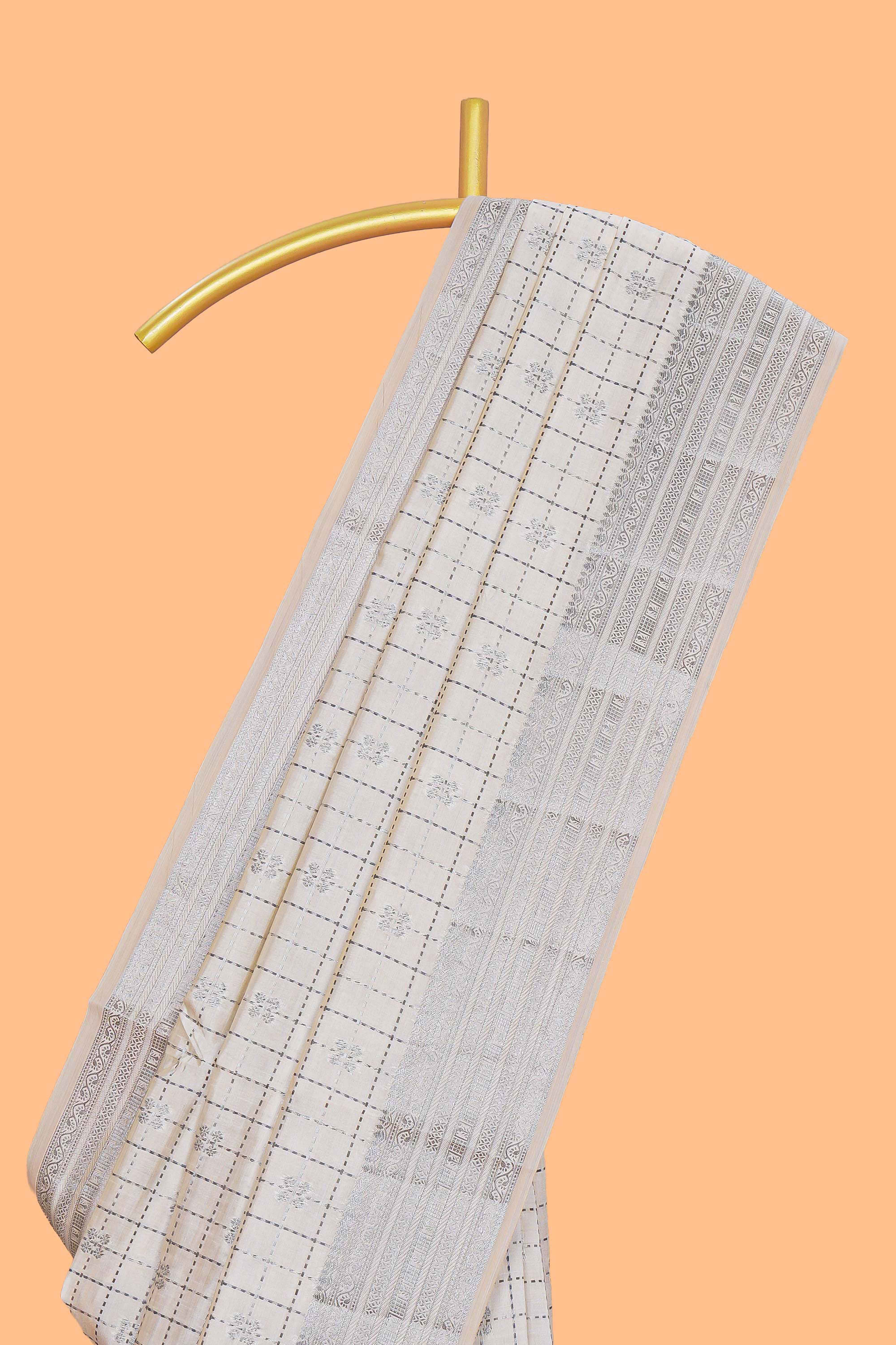 Off white checked zari design raw silk saree with self zari border and matching striped blouse